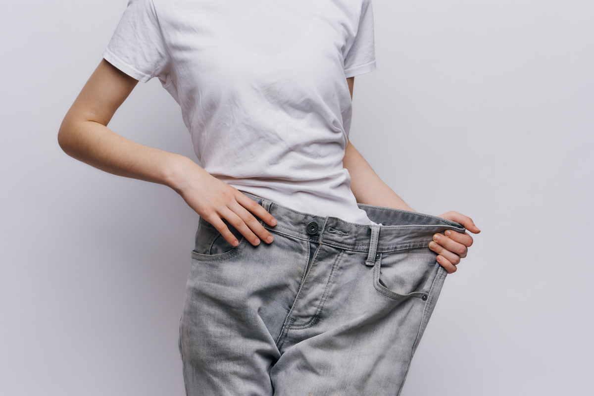 Woman on a Weight Loss Diet Large Pants Measuring a Slim Figure
